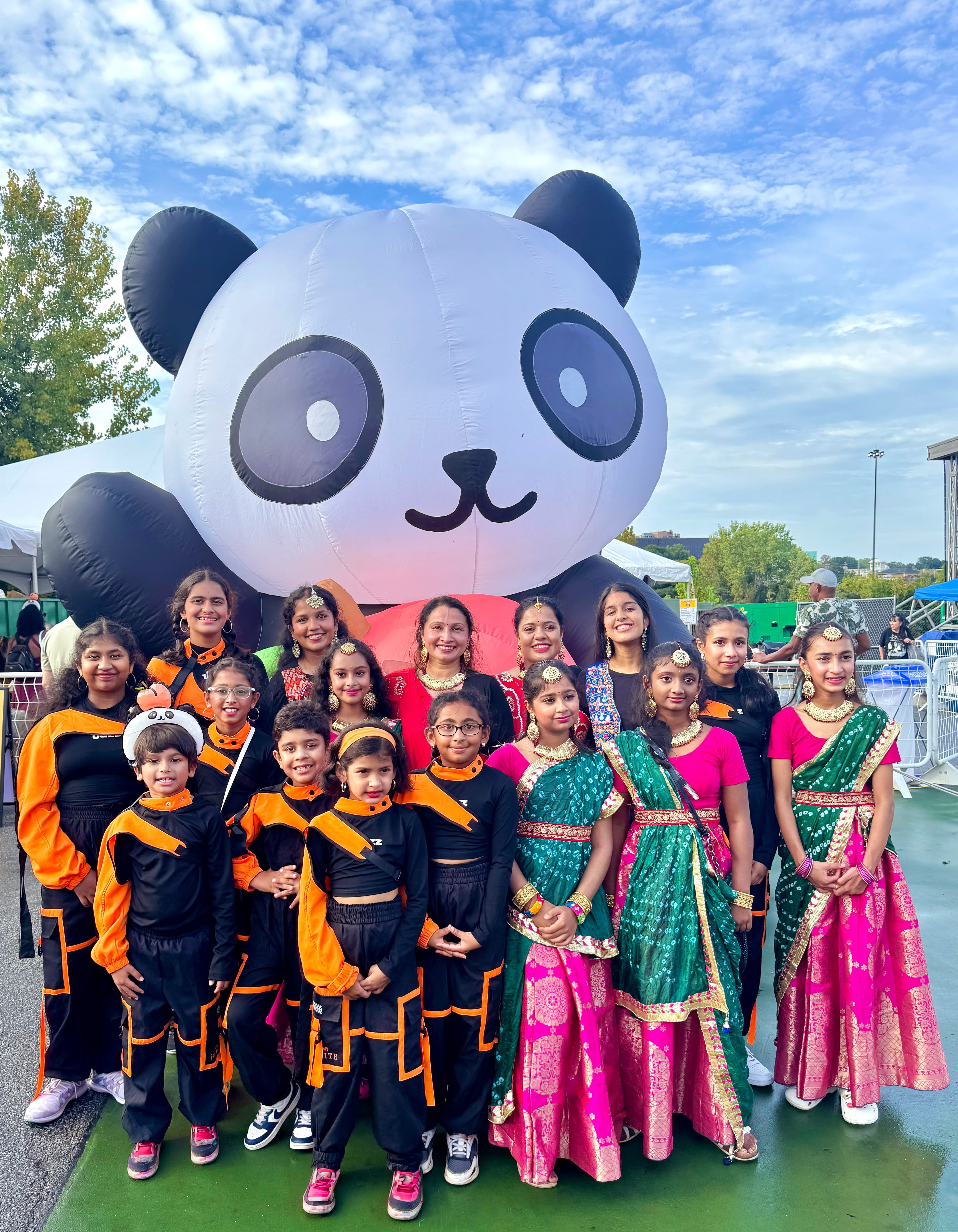Garima Dance Academy fusion group in mixed traditional and modern costumes, outdoor festival stage